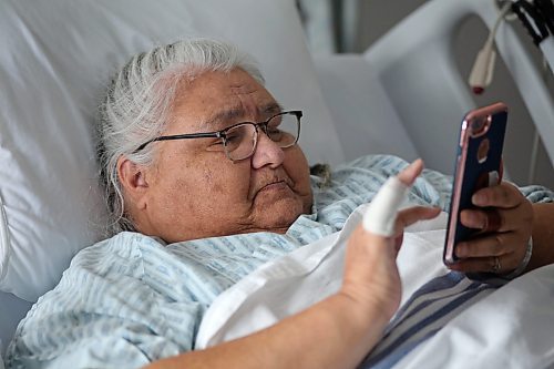 From her hospital room at the Souris Health Centre, Lucy Demeria flips through pictures of some of the injuries she sustained after falling from a handi-transit lift in that community last October. She has remained in the Souris Health Centre recuperating since that time. (Matt Goerzen/The Brandon Sun)