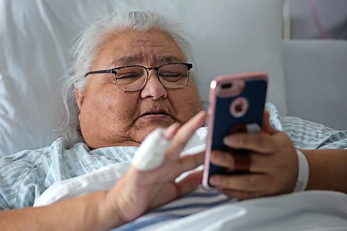 From her hospital room at the Souris Health Centre, Lucy Demeria flips through pictures of some of the injuries she sustained after falling from a handi-transit lift in that community last October. She has remained in the Souris Health Centre recuperating since that time. (Matt Goerzen/The Brandon Sun)