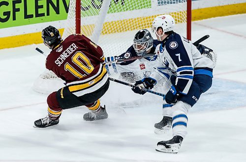 JOHN WOODS / WINNIPEG FREE PRESS
Manitoba Moose goaltender Collin Delia (60) saves the shot from Chicago Wolves&#x2019; Cole Schneider (10) as Simon Lundmark (7) defends during first period AHL action in Winnipeg on Tuesday, January 23, 2024.

Reporter: josh