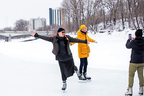 MIKAELA MACKENZIE / WINNIPEG FREE PRESS
	
Stephanie Chow films Chloe Chafe (left) and Andrew Eastman (all Forks employees) skating on the Nestaweya River Trail on opening day at The Forks on Thursday, Jan. 25, 2024. For Malak (?) story or standup.
Winnipeg Free Press 2024