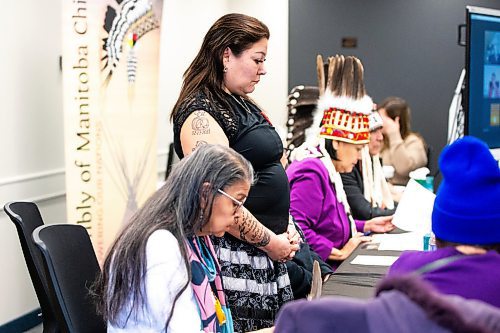 MIKAELA MACKENZIE / WINNIPEG FREE PRESS
	
Melissa Robinson stands as Geraldine (Gramma) Shingoose does an opening prayer at a press conference announcing the completion of the Inter-Related Operational Planning Report on Thursday, Jan. 25, 2024. For Nicole story.
Winnipeg Free Press 2024