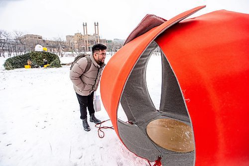 MIKAELA MACKENZIE / WINNIPEG FREE PRESS
	
Kristian Escoto checks out new 2024 warming hut Spinning Dim Sum at The Forks on Friday, Jan. 26, 2024. For photo page.
Winnipeg Free Press 2024