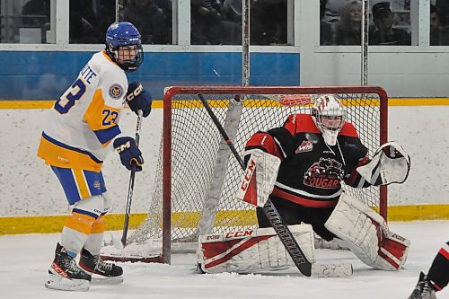 With Southwest Cougars goalie Evan Svoboda (1) bracing for a shot from the point, Brandonite Quinn Schutte (23) looks for a rebound during a Yellowhead Chiefs powerplay. Early in the second period, the Chiefs led 2-1. (Photos by Jules Xavier/The Brandon Sun)