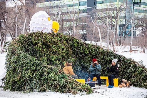 MIKAELA MACKENZIE / WINNIPEG FREE PRESS
	
Max Koltek (left), Heather Hinam, and Erika Jordan warm up in the new 2024 warming hut Circling Above Us
by Wayne and Jordan Stranger at The Forks on Friday, Jan. 26, 2024. For photo page.
Winnipeg Free Press 2024