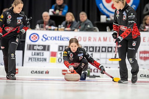 BROOK JONES / WINNIPEG FREE PRESS
Skip Kaitlyn Lawes of Team Lawes from the Fort Rouge Curling Club competes in the 2024 Manitoba Women's Curling Championships - Scotties Tournament of Hearts presented by Rocky Mountain Equipment at the Access Event Centre in Morden, Man., Friday, Jan. 26, 2024. Members of Team Lawes also include third Selena Njejovan, second Jocelyn Peterman and lead Kristin MacCuish. Pictured: Lawes  (middle) delivers a rock while teammates Peterman (left) and MacCuish (right) prepare to sweep during her team's match against Team Peterson from the Assiniboine Memorial Curling Club Friday, Jan. 26, 2024. Team Lawes earned an 8-6 victory over Team Peterson.