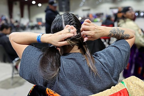 26012024
Nadine Obey of Regina braids her hair while preparing for the women&#x2019;s fancy dance category at the Dakota Nation Winterfest Powwow at the Keystone Centre on Friday evening. The weekend-long Winterfest includes square dancing, Moccasin games, basketball, volleyball and a variety of other events.
(Tim Smith/The Brandon Sun)
