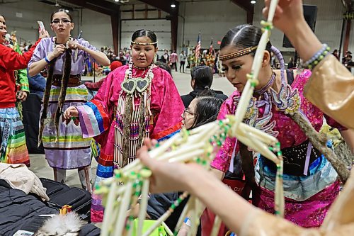 26012024
Dancers put on their regalia before taking part in the Powwow Grand Entry at the Dakota Nation Winterfest at the Keystone Centre on Friday evening. The weekend-long Winterfest includes square dancing, Moccasin games, basketball, volleyball and a variety of other events.
(Tim Smith/The Brandon Sun)
