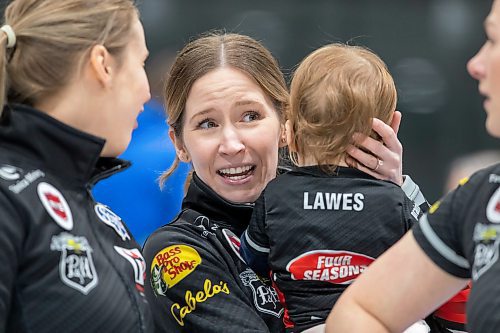 BROOK JONES / WINNIPEG FREE PRESS
Skip Kaitlyn Lawes of Team Lawes from the Fort Rouge Curling Club holds her 13-month-old daughter Myla Vigier while talking with teammate Jocelyn Peterman (left), who plays second, after winning the final of 2024 Manitoba Women's Curling Championships - Scotties Tournament of Hearts presented by Rocky Mountain Equipment at the Access Event Centre in Morden, Man., Sunday, Jan. 28, 2024. Members of Team Lawes also include third Selena Njejovan, and lead Kristin MacCuish. Pictured: Team Lawes earned a 9-8 victory over Team Peterson from the Assiniboine Memorial Curling Club.
