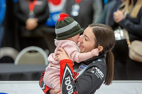 BROOK JONES / WINNIPEG FREE PRESS
Skip Beth Peterson of Team Peterson from the Assiniboine Memorial Curling Club holds her daughter seven-month-old daughter Ellie Turnbull after competing in the final of 2024 Manitoba Women's Curling Championships - Scotties Tournament of Hearts presented by Rocky Mountain Equipment at the Access Event Centre in Morden, Man., Sunday, Jan. 28, 2024. Members of Team Peterson also include third Kelsey Rocque , second Katherine Doerksen, lead Melissa Gordon Kurz and alternate Jenna Loder. Team Peterson was defeated 9-8 by Team Kaitlyn Lawes from the Fort Rouge Curling Club.