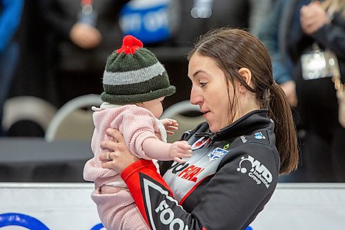 BROOK JONES / WINNIPEG FREE PRESS
Skip Beth Peterson of Team Peterson from the Assiniboine Memorial Curling Club holds her daughter seven-month-old daughter Ellie Turnbull after competing in the final of 2024 Manitoba Women's Curling Championships - Scotties Tournament of Hearts presented by Rocky Mountain Equipment at the Access Event Centre in Morden, Man., Sunday, Jan. 28, 2024. Members of Team Peterson also include third Kelsey Rocque , second Katherine Doerksen, lead Melissa Gordon Kurz and alternate Jenna Loder. Team Peterson was defeated 9-8 by Team Kaitlyn Lawes from the Fort Rouge Curling Club.