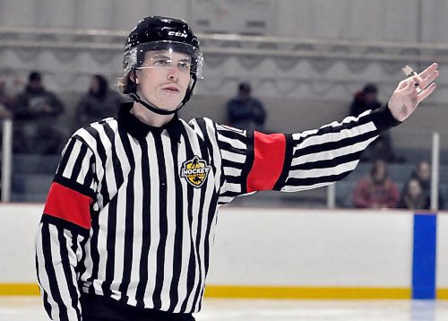 In his seventh season of officiating with Hockey Manitoba, Carter Loewen signals a penalty during a recent high school game at Flynn Arena. On most nights doing senior, Manitoba U18 AAA Hockey League or Manitoba Junior Hockey League games he's working the lines, not as a referee in a four-man system. (Photos by Jules Xavier/The Brandon Sun)