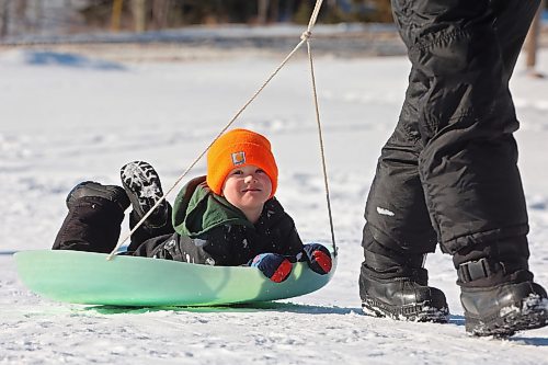 Kevin Gulay pulls his son Andrew, 4, up the hill while the Gulay family enjoys sledding at Elkhorn Resort in Riding Mountain National Park on a clear and warm Monday afternoon. Temperatures in Westman are set to be stay well above normal all week. (Tim Smith/The Brandon Sun)