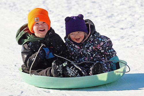 29012024
Siblings Andrew and Clara Gulay smile while sledding at Elkhorn Resort in Riding Mountain National Park on a clear and warm Monday afternoon. Temperatures in Westman are set to be stay well above normal all week. 
(Tim Smith/The Brandon Sun)
