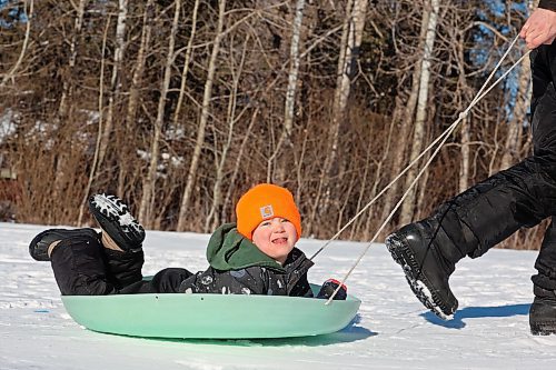 29012024
Kevin Gulay pulls his son Andrew, four, back up the hill while the Gulay family enjoys sledding at Elkhorn Resort in Riding Mountain National Park on a clear and warm Monday afternoon. Temperatures in Westman are set to be stay well above normal all week. 
(Tim Smith/The Brandon Sun)