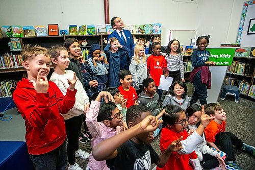 MIKAELA MACKENZIE / WINNIPEG FREE PRESS

Premier Wab Kinew poses with students after announcing a universally accessible school nutrition program at St. George School on Tuesday, Jan. 30, 2024. For Maggie story.
Winnipeg Free Press 2024.