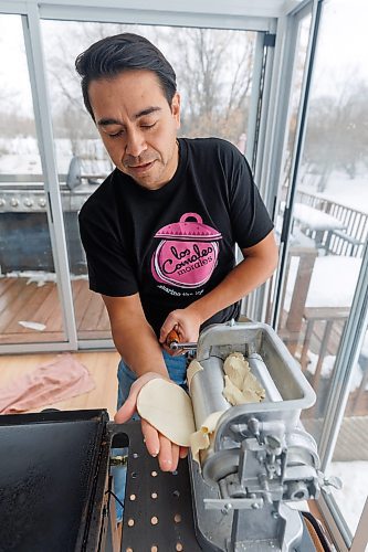 MIKE DEAL / WINNIPEG FREE PRESS
Eduardo Morales puts the tortilla dough through his tortilla maker before placing them on the griddle.
Helena and Eduardo Morales, owners of Los Comales Morales, an artisan tortilla business. 
Helena and Eduardo are both of Mexican descent, she grew up in Manitoba, while Eduardo moved here from Mexico City in 2006, after the two of them met through a friend. 
Eduardo missed the taste of authentic, corn tortillas so he bought an industrial tortilla maker in 2018, and began ordering non-GMO, organic corn flour from a distributor in Iowa, expressly to make tortillas for family and friends. But since he was required to buy one ton of flour, per order, he started thinking maybe others would enjoy their tortillas, too; the business launched in August, 2023.
240130 - Tuesday, January 30, 2024.
