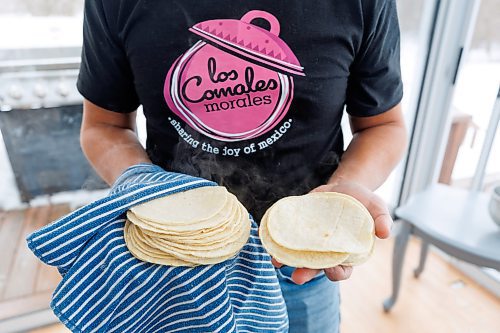 MIKE DEAL / WINNIPEG FREE PRESS
Eduardo Morales collects the hot tortillas in a cloth to keep them warm while he works his way through the dough.
Helena and Eduardo Morales, owners of Los Comales Morales, an artisan tortilla business. 
Helena and Eduardo are both of Mexican descent, she grew up in Manitoba, while Eduardo moved here from Mexico City in 2006, after the two of them met through a friend. 
Eduardo missed the taste of authentic, corn tortillas so he bought an industrial tortilla maker in 2018, and began ordering non-GMO, organic corn flour from a distributor in Iowa, expressly to make tortillas for family and friends. But since he was required to buy one ton of flour, per order, he started thinking maybe others would enjoy their tortillas, too; the business launched in August, 2023.
240130 - Tuesday, January 30, 2024.