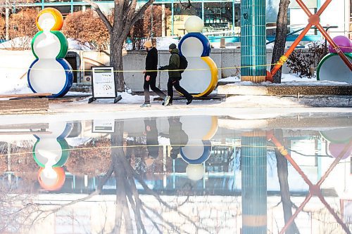 MIKAELA MACKENZIE / WINNIPEG FREE PRESS

Navdeep Sharma (left) and Nitesh Goswami walk past the closed (and partially melted) canopy rink at The Forks on Tuesday, Jan. 30, 2024. For Malak story.
Winnipeg Free Press 2024.