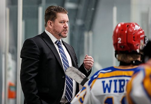 JOHN WOODS / WINNIPEG FREE PRESS
Mike Reagan, coach of the SJHL team, behind the bench at the MJHL-SJHL Showcase in Winnipeg Tuesday, January 30, 2024. 

Reporter: mike