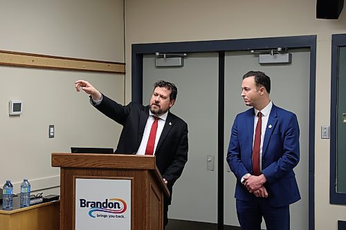 Brandon East NDP MLA Glen Simard (left) and Finance Minister Adrien Sala discuss Manitoba's fiscal situation during a budget consultation session at a Riverbank Discovery Centre on Wednesday evening. (Colin Slark/The Brandon Sun)