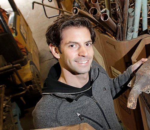 Adam Chisick, vice pres. of Urbanmine Metal Recycling, a metal recycling company that buys and recycles catalytic converters.  He is holding two from their box of catalytic converters.  Aidan Geary story  Wayne Glowacki/Winnipeg Free Press Oct.30   2014