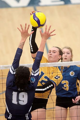 02022024
Avery Burgar #12 of the Brandon University Bobcats spikes the ball past Mya Morgan #19 of the Mount Royal University Cougars during women&#x2019;s university volleyball action at the BU Healthy Living Centre on Friday evening.
(Tim Smith/The Brandon Sun)