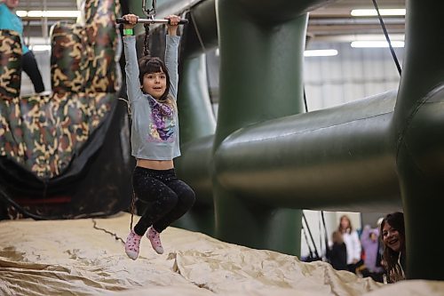 Ivy Goossen, 8, enjoys a ride on the mobile zipline at the Family Fun Day on Saturday. Photos: Abiola Odutola/The Brandon Sun