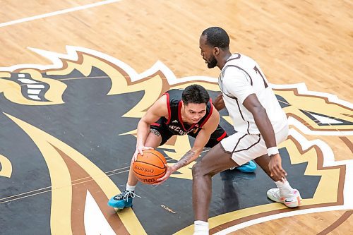 BROOK JONES / WINNIPEG FREE PRESS
The University of Manitoba Bisons host the visiting University of Winnipeg Wesmen in Canada West women's basketball action at the Investors Group Athletic Centre at the University of Manitoba Fort Garry campus in Winnipeg, Man., Saturday, Feb. 3, 2024. Pictured: Wesmen guard Shawn Maranan (No. 5) controls the basketball as Bisons guard Tito Obasoto (No. 7) guards him during second half action.