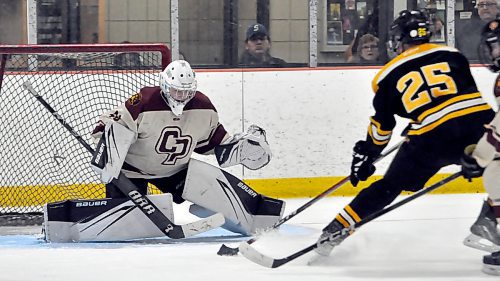 Crocus Plainsmen netminder Kelsey Dell stopped Neepewa Tigers forward Tarek Lapointe (25) in close on this third-period save during high school action Sunday night at Flynn Arena. Dell faced 59 shots during her team's 10-4 loss. (Jules Xavier/The Brandon Sun)