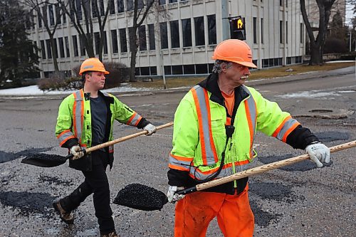 05022024
Nathaniel Hegg and Harry Davis with Manitoba Transportation and Infrastructure fill potholes with asphalt at the intersection of 18th Street and Victoria Avenue in Brandon on a mild Monday. The constant free/thaw cycle of our recent mild weather has kept road crews busy with pothole repairs. 
(Tim Smith/The Brandon Sun)