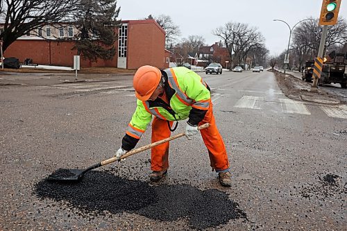 05022024
Harry Davis with Manitoba Transportation and Infrastructure fills potholes with asphalt at the intersection of 18th Street and Victoria Avenue in Brandon on a mild Monday. The constant free/thaw cycle of our recent mild weather has kept road crews busy with pothole repairs. 
(Tim Smith/The Brandon Sun)
