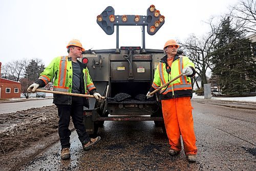 05022024
Nathaniel Hegg and Harry Davis with Manitoba Transportation and Infrastructure watch for a break in traffic to fill potholes with asphalt at the intersection of 18th Street and Victoria Avenue in Brandon on a mild Monday. The constant free/thaw cycle of our recent mild weather has kept road crews busy with pothole repairs. 
(Tim Smith/The Brandon Sun)
