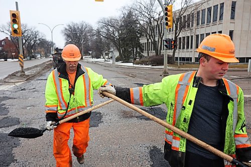 05022024
Harry Davis and Nathaniel Hegg with Manitoba Transportation and Infrastructure fill potholes with asphalt at the intersection of 18th Street and Victoria Avenue in Brandon on a mild Monday. The constant free/thaw cycle of our recent mild weather has kept road crews busy with pothole repairs. 
(Tim Smith/The Brandon Sun)