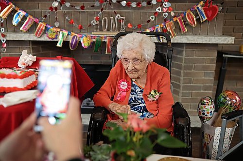 07022024
Longtime family friend Ricki Woods takes photos of 112-year-old Hazel Skuce as she celebrates her birthday with residents, staff and visitors at Extendicare Hillcrest Place Personal Care Home in Brandon on Wednesday afternoon.
(Tim Smith/The Brandon Sun)