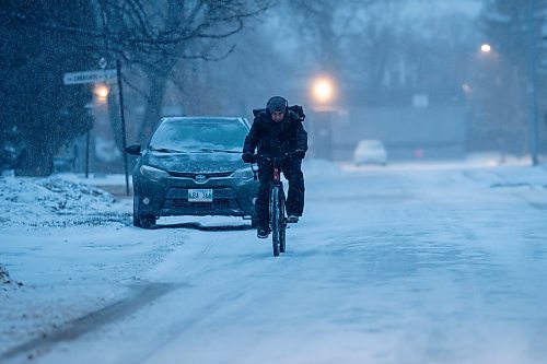 BROOK JONES./ WINNIPEG FREE PRESS
Winnipeg resident Darin Belcourt, who is originally from Vancouver, B.C., braves the wind and snow and icy road conditions as he cycles on his way home down Comanche Road in Winnipeg, Man., Thursday, Feb. 8, 2024.