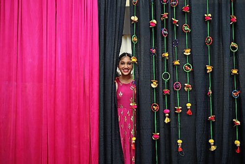 09022024
Milan Kaur peeks out from behind curtains while watching fellow performers dance at the India pavilion in the Victoria Inn Imperial Ballroom during day two of the Westman Multicultural Festival on Friday evening. 
(Tim Smith/The Brandon Sun)