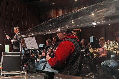 09022024
Students in the Westman Senior Honour Band are reflected in the side of a piano as Dr. Mark Tse leads an all day rehearsal on Friday at the Western Manitoba Centennial Auditorium in advance of their performance at the auditorium today. The Junior Honour Band also rehearsed and will be performing today as well. 
(Tim Smith/The Brandon Sun)