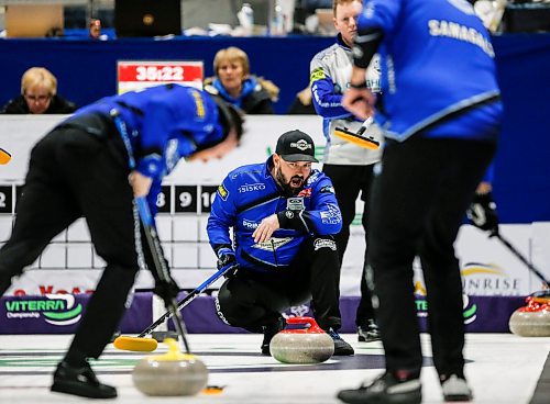 Reid Carruthers watches the progress of a stone under the watchful eye of Carberry's Braden Calvert, background, in the Manitoba men's curling championship in Stonewall on Sunday. Carruthers won 6-3 and will represent Manitoba at the Brier. (John Woods/Winnipeg Free Press)