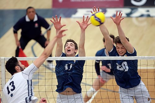 Paycen Warkentin, right, closes a block beside right side Riley Grusing against Mount Royal University earlier this month. Warkentin enters this weekend second in the country in blocks behind teammate Philipp Lauter.
(Tim Smith/The Brandon Sun)