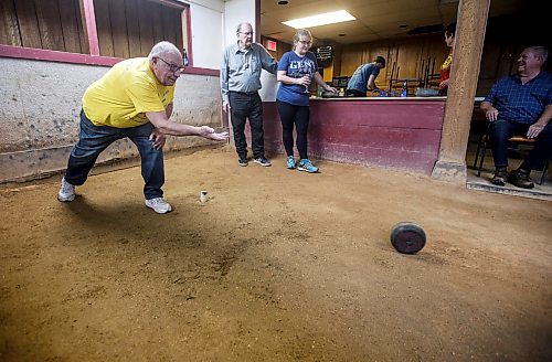 JOHN WOODS / WINNIPEG FREE PRESS
 Albert Delbaere and Lisa Boone, background, look on as George DeSerranno releases his bolle during the Tuesday Night Bowlers league at the Belgian Bowling alley in the basement of the Belgian Club Tuesday, January 30, 2024. 

Reporter: dave