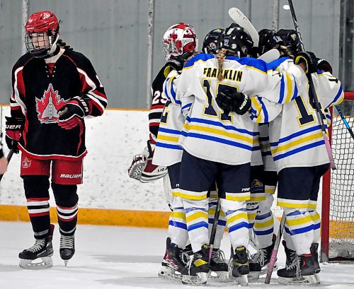 Westman Wildcats rearguard Hallie Franklin (17) and her teammates huddle to celebrate teammate Paige Crossley's power-play goal on Winnipeg Avros goalie Madelynne Sylvestre in the second period. The Wildcats went three-for-six with the man advantage en route to a 3-1 victory over the Avros to close out the U18 AAA Manitoba Female Hockey League regular season in Hartney Saturday night. (Jules Xavier/The Brandon Sun)