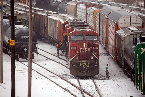 A worker with CPKC rail jumps from a locomotive in the company's Brandon railyard on Tuesday afternoon. (Matt Goerzen/The Brandon Sun)