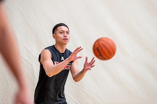 BROOK JOJNES / WINNIPEG FREE PRESS
University of Winnipeg Wesmen men's basketball team guard Shawn Maranan, who graduated from &#xc9;cole Sisler High School, is pictured catching a basketball pass during a team practice at the Dr. David F. Anderson Gymnasium inside the Duckworth Centre at the University of Winnipeg in Winnipeg, Man., Tuesday, Feb. 13, 2024.