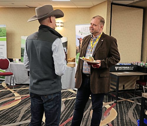 The in-coming president of Canada Beef Eric Bienvenue, right, talks with the president of the Manitoba Beef Producers, Matthew Atkinson (left), during the annual general meeting of the Manitoba Beef Producers in Brandon's Victoria Inn on Feb. 8. Atkinson has retained his title of president for 2024-25, with Arvid Nottveit as vice-president and Tyler Fulton as second vice president. (Michele McDougall/The Brandon Sun)