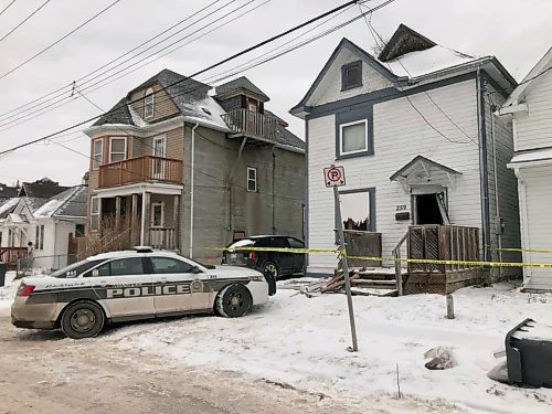 Police outside the scene at 259 Magnus Ave. (Erik Pindera/Winnipeg Free Press)