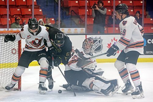 Brandon Wheat Kings forward Matt Henry (67) digs for the puck between Calgary Hitmen defenceman Fraser Leonard (27) and goalie Ethan Buenaventura (29) during first period WHL action at Westoba Place Friday night. (Tim Smith/The Brandon Sun)