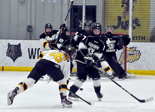 Brandon Wheat Kings rearguard Callie Franklin (16) fires a shot through the legs of Eastman Selects forward Lilly Leefe (7) during first-period action at J&G Homes Arena in December. (Jules Xavier/The Brandon Sun)