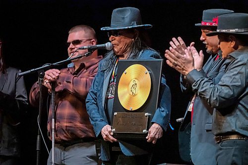 BROOK JONES / WINNIPEG FREE PRESS
Ernest Monias, who is also known as &quot;Elvis of the North&quot; and &quot;King of the North,&quot; is a country music rocker from Pimicikamak Cree Nation. Monias (second from far left) holds a gold record recognizing his 25 music albums he was presented with during an honouring ceremony in celebration of his 75th birthday at the Burton Cummings Theatre in Winnipeg, Man., Sunday, Feb. 18, 2024. Also pictured are Monias' manager Brent Hudson (far left), Shawn Mann (seond from far right) from Tribal Road Entertainment and C-Weed lead singer/songwriter Errol Ranville (far right).