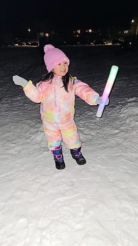 Three-year-old Nico Veles shows off the glow stick she received at Neepawa's Winter Festival, which took place on the evening of Feb. 18 and featured skating, free hot dogs and hot chocolate, sleigh rides, glow-in-the-dark trails, fireworks and more. (Miranda Leybourne/The Brandon Sun)