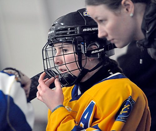 An assistant captain on the Yellowhead Chiefs this season, forward Mia McGregor listens to strategy on the bench from assistant captain Cass Lyttle during her team's 4-1 win during the final game of the 2023-24 season hosting the Winnipeg Avros in Shoal Lake. (Jules Xavier/The Brandon Sun)